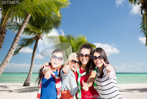 Image of teenage girls or young women showing thumbs up