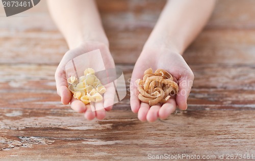 Image of female hands with different pasta variations