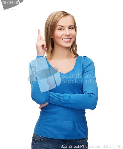 Image of smiling woman pointing her finger up