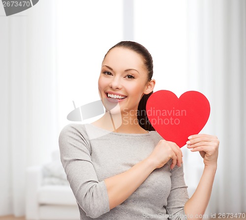 Image of smiling asian woman with red heart