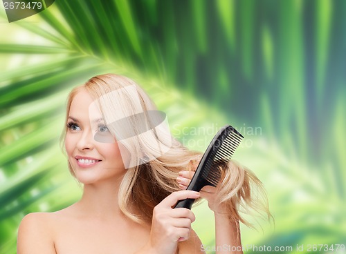 Image of smiling woman with hair brush