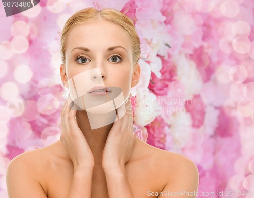 Image of beautiful woman touching her face skin