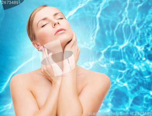 Image of beautiful woman touching her face with closed eyes