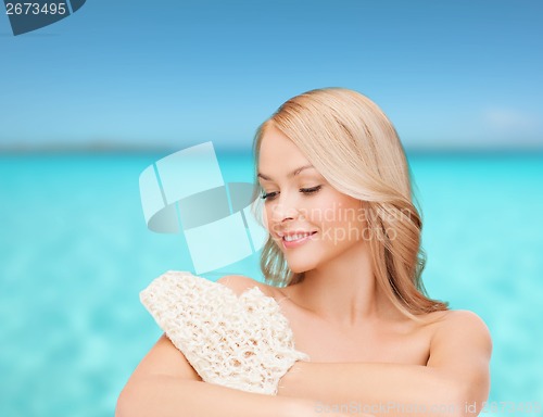 Image of smiling woman with exfoliation glove
