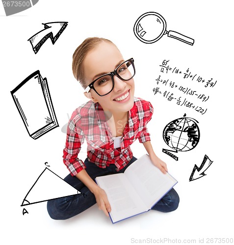 Image of smiling teenage girl in eyeglasses reading book