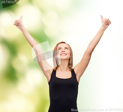 Image of woman in blank black tank top showing thumbs up