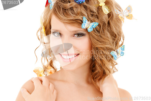 Image of happy teenage girl with butterflies in hair