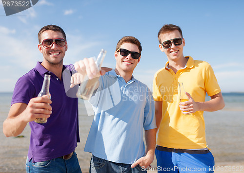 Image of group of male friends with bottles of beer