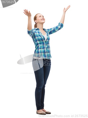 Image of smiling young woman waving hands