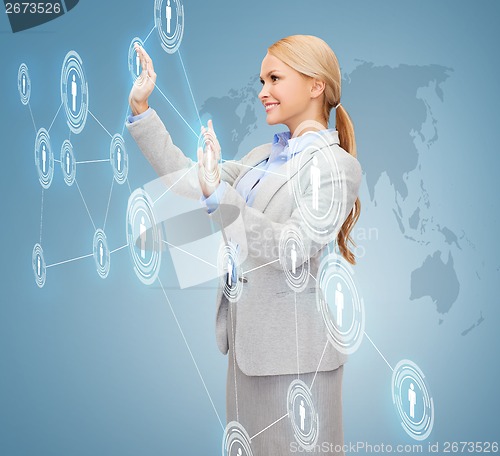 Image of smiling businesswoman working with virtual screen