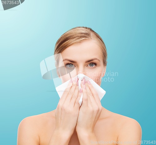 Image of beautiful woman with paper tissue