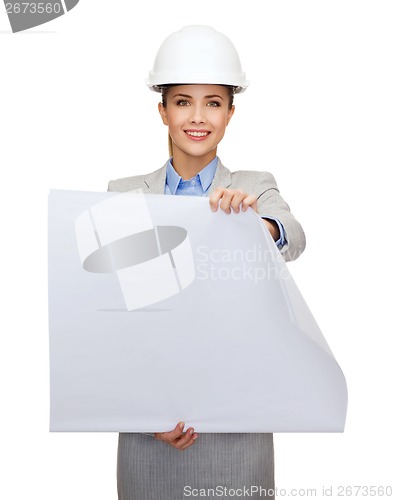 Image of smiling architect in white helmet with blueprints