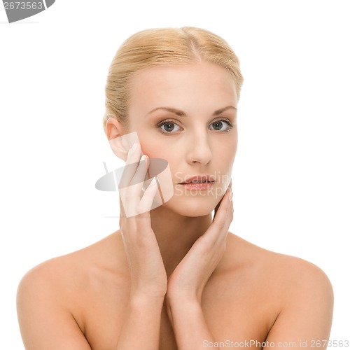 Image of beautiful woman touching her face skin