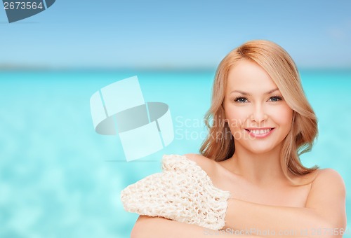 Image of smiling woman with exfoliation glove