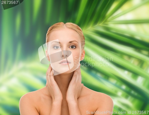 Image of beautiful woman touching her face skin