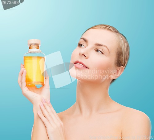 Image of lovely woman with oil bottle