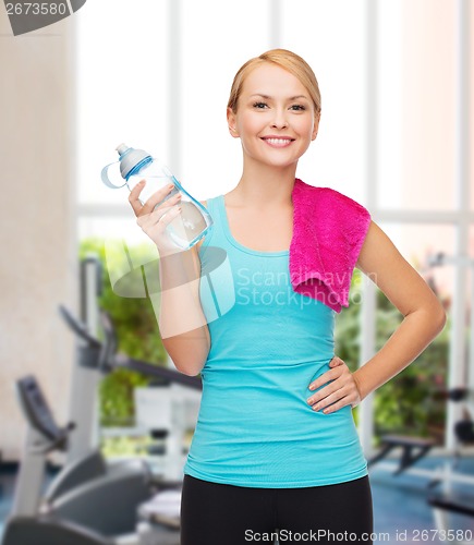 Image of sporty woman with towel and watel bottle