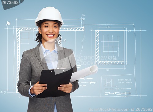 Image of businesswoman in white helmet with clipboard