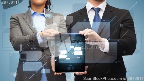 Image of businessman and businesswoman with tablet pc