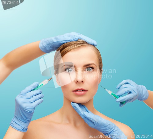 Image of woman face and beautician hands with syringe