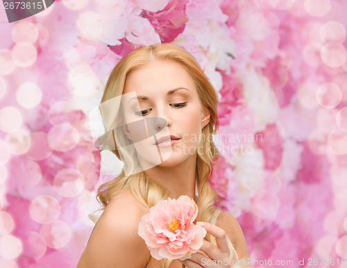 Image of lovely woman with peony flower