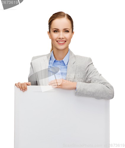 Image of smiling businesswoman with white blank board