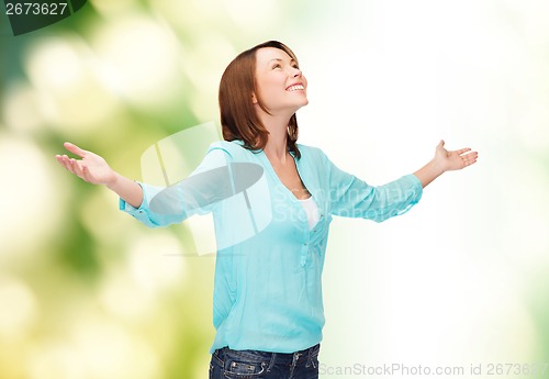 Image of smiling woman waving hands