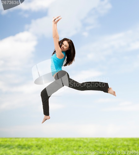 Image of sporty woman jumping in sportswear