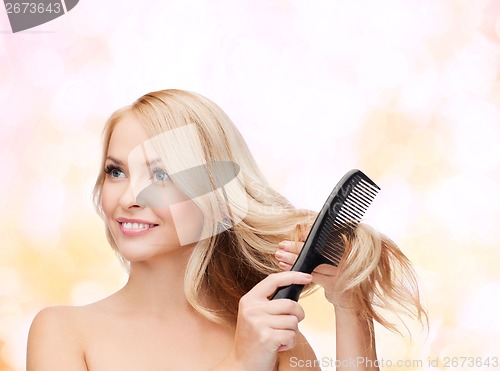 Image of smiling woman with hair brush