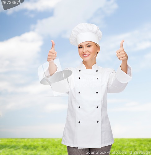 Image of smiling female chef showing thumbs up