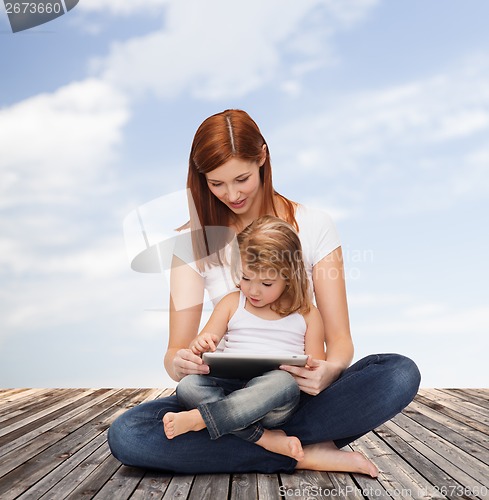 Image of happy mother with little girl and tablet pc