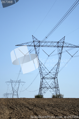 Image of Electricity pylons in ploughed land