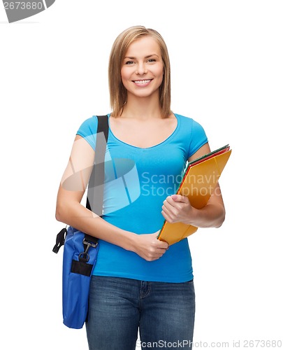 Image of smiling female student with bag and folders