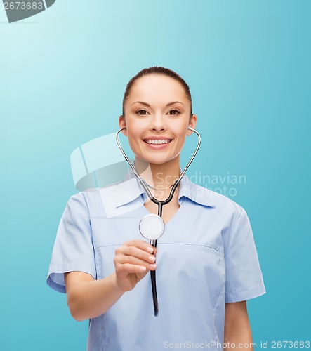 Image of smiling female doctor or nurse with stethoscope