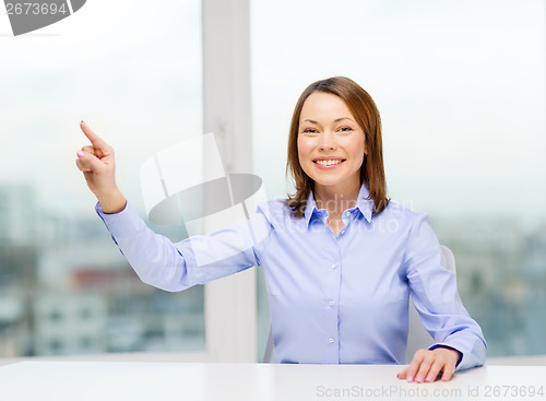 Image of smiling woman pointing to something imaginary