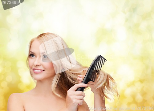 Image of smiling woman with hair brush