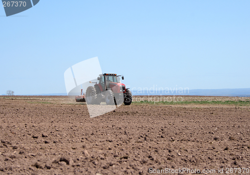 Image of Tractor plowing land