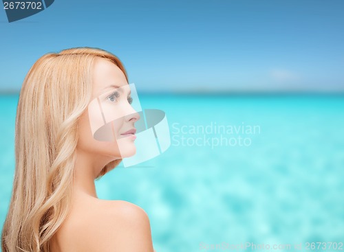 Image of face and shouldes of happy woman with long hair
