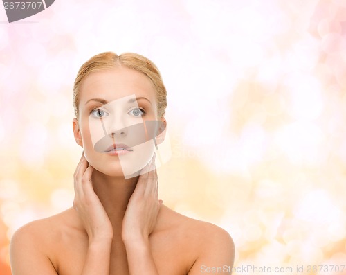 Image of beautiful woman touching her face skin