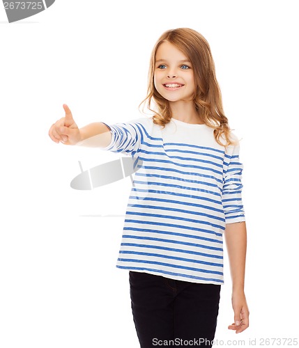 Image of cute girl pointing in the air or virtual screen