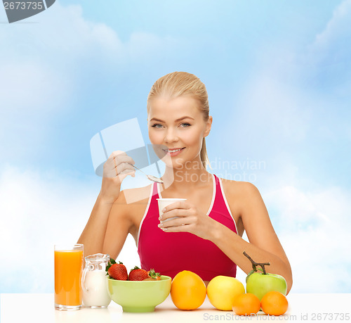 Image of young woman eating healthy breakfast