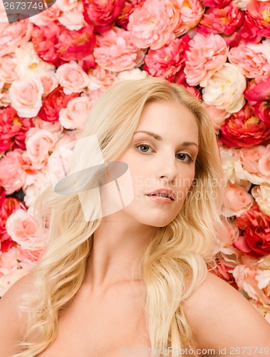 Image of beautiful woman and background full of roses