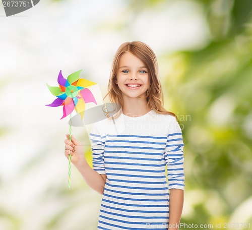 Image of smiling child with colorful windmill toy