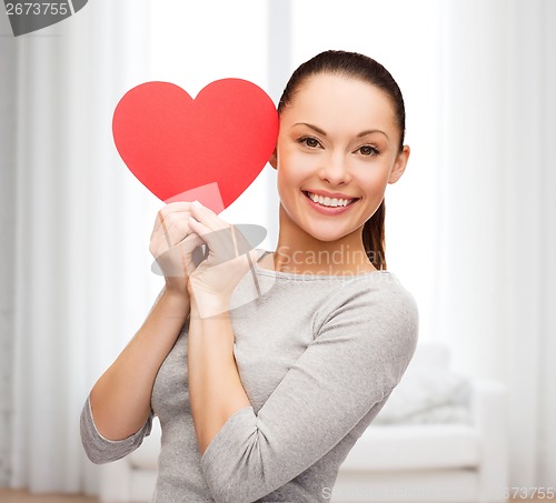 Image of smiling asian woman with red heart