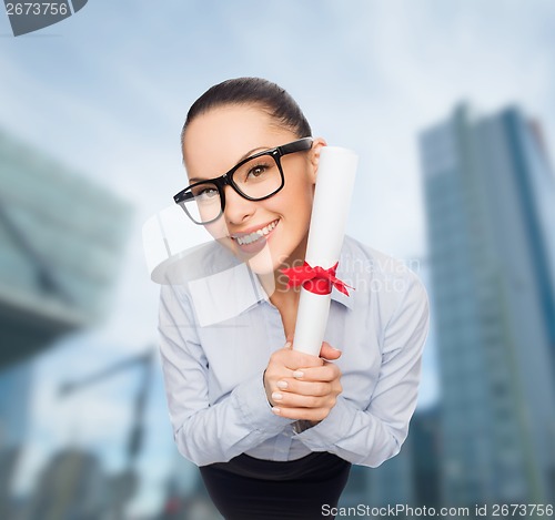 Image of smiling businesswoman in eyeglasses with diploma