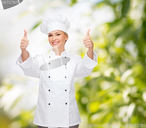 Image of smiling female chef showing thumbs up