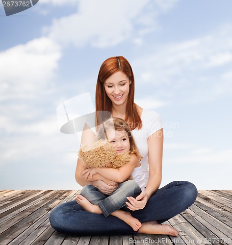 Image of happy mother with adorable girl and teddy bear