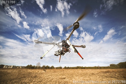 Image of Quadrocopter drone flying in the sky