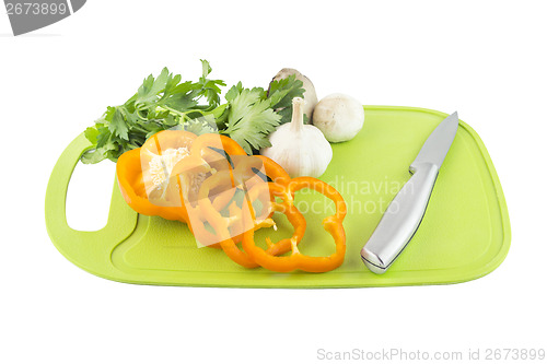 Image of Parsley and mushroom on green Plastic board