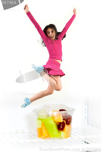 Image of teen jumping over fruit cup